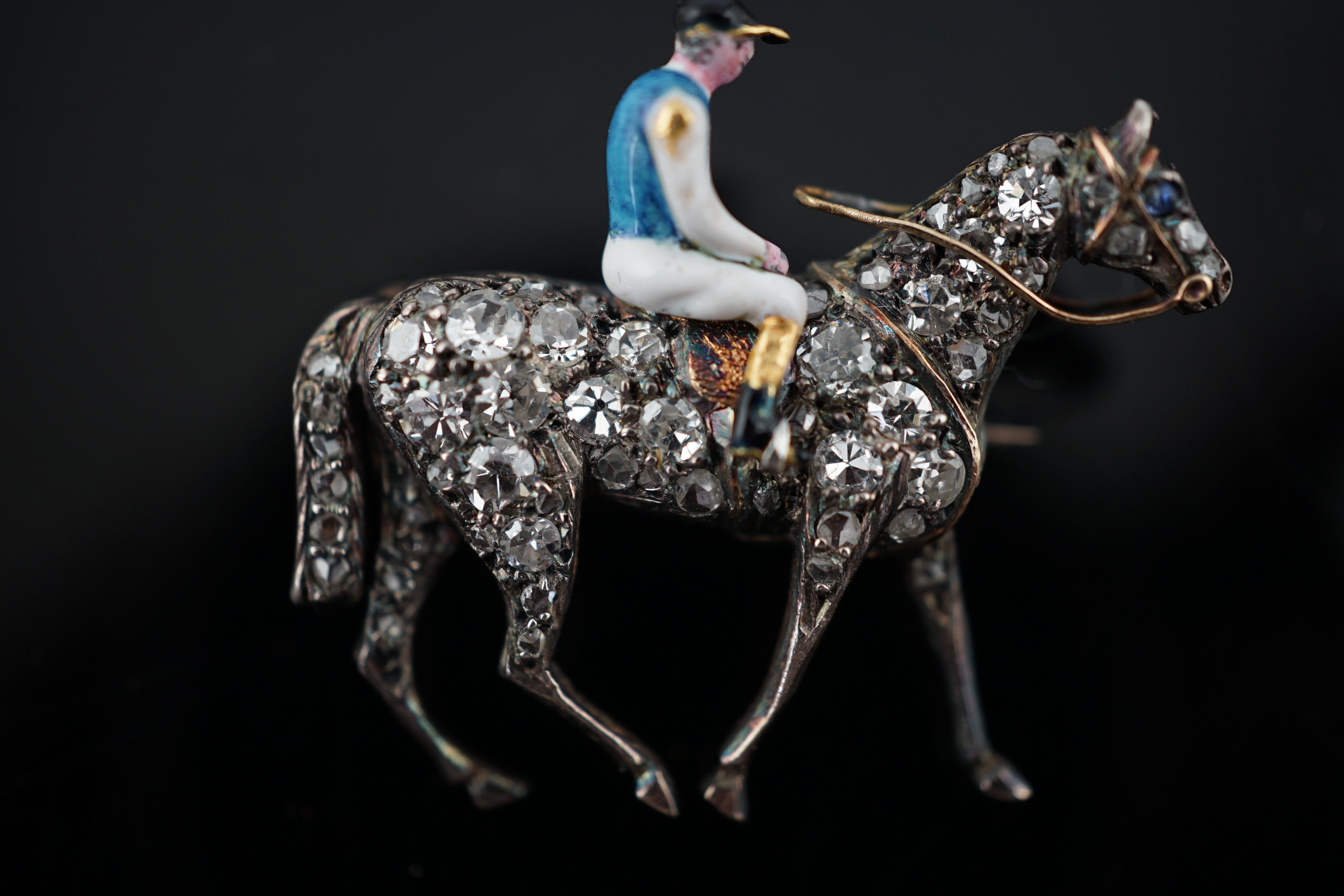 A late Victorian gold, rose cut diamond and polychrome enamel set horse and jockey brooch